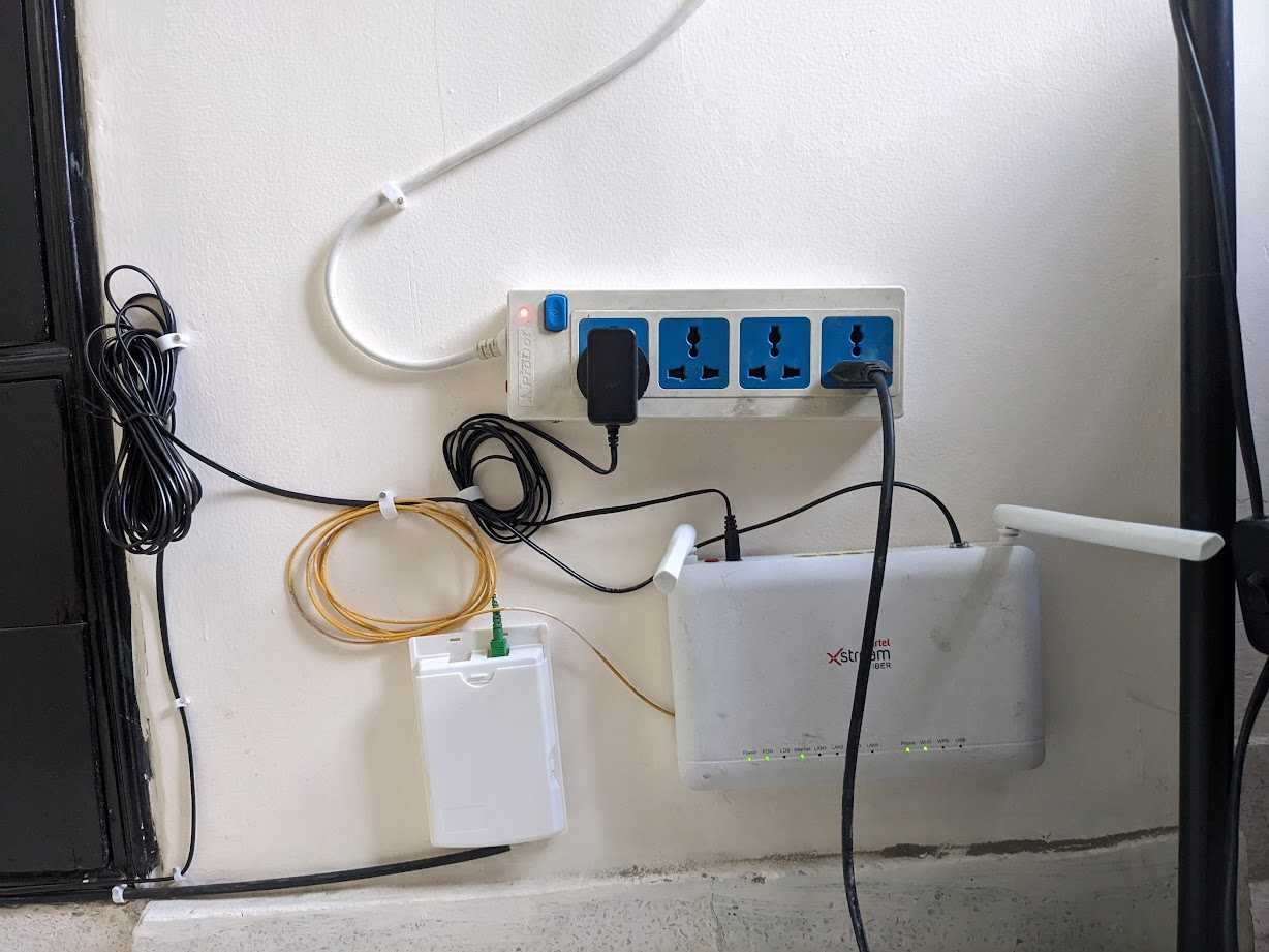 Neatly wrapped wires and internet equipment drilled to a wall